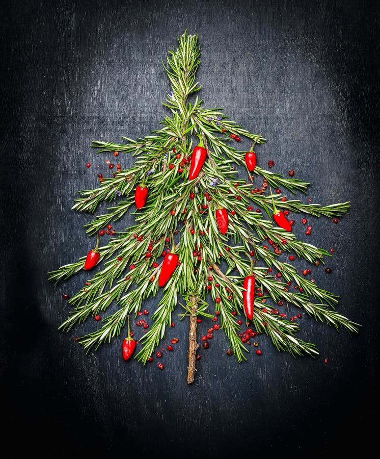 Arbre de Noël de nourriture fait de romarin frais et piment rouge sur le fond foncé photos libres de droits Arbre de Noël de nourriture fait de romarin frais et piment rouge sur le fond foncé photos libres de droits