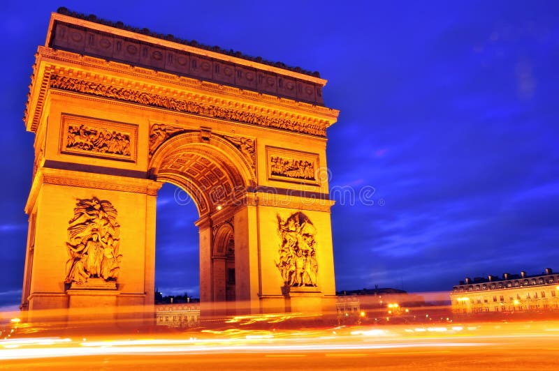 The Arc de Triomphe at night in Paris, France.