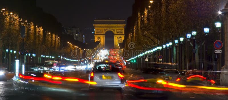 Creative night photograph in letterbox format of cars speeding along the Champs Elysees towards the Arc De Triomphe. Creative night photograph in letterbox format of cars speeding along the Champs Elysees towards the Arc De Triomphe.