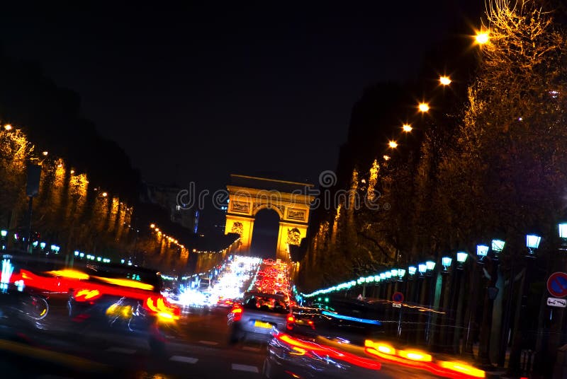 Creative night photograph looking from Place de la Concorde to the Arc de Triomphe with car headlight streaks. Creative night photograph looking from Place de la Concorde to the Arc de Triomphe with car headlight streaks.