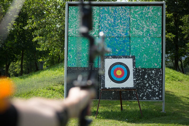 Archer holds his bow aiming at a target stock images Archer holds his bow aiming at a target stock images