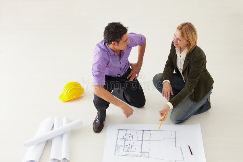 High angle view of male architect and woman examining blueprints. Copy space. Co working space stock images, royalty-free photos and pictures