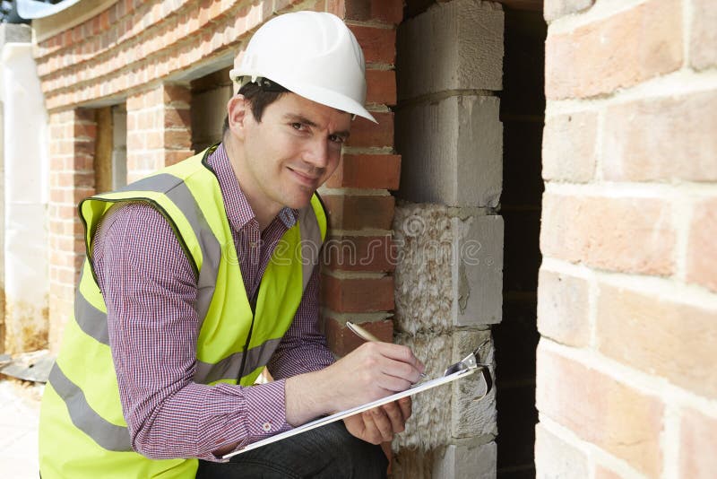 Architect Checking Insulation During House Construction royalty free stock images Architect Checking Insulation During House Construction royalty free stock images
