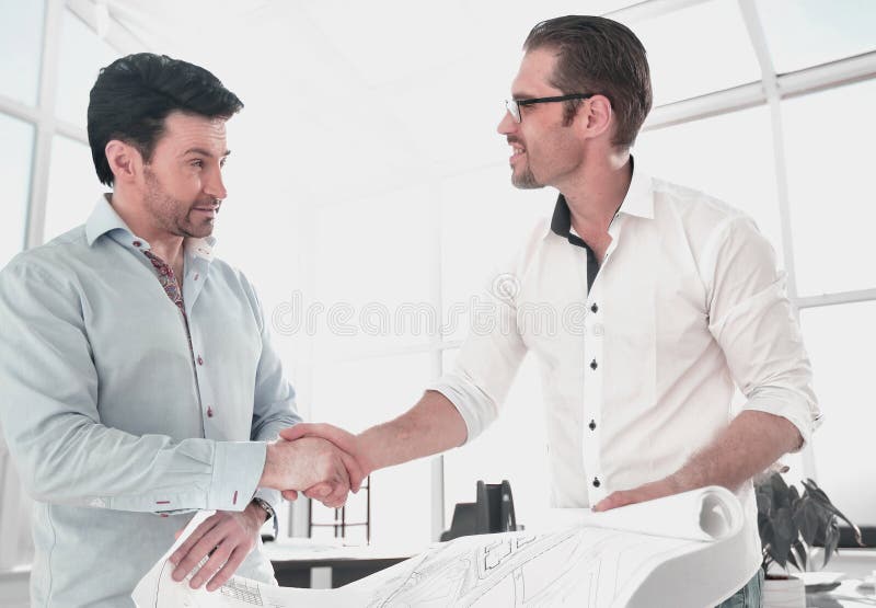 Architect and client handshake in the office stock photos