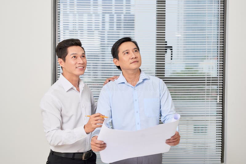 Architect Discussing Their Project in the Office with Partner Stock