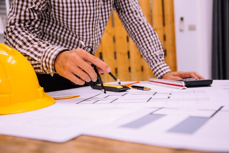 Engineer Man and Architect Drawings Blueprint at Construction Site.Home