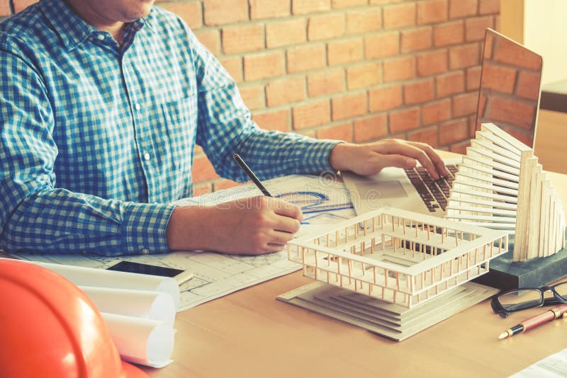 Architect or Engineer Working in Office on Blueprint. Architects Stock