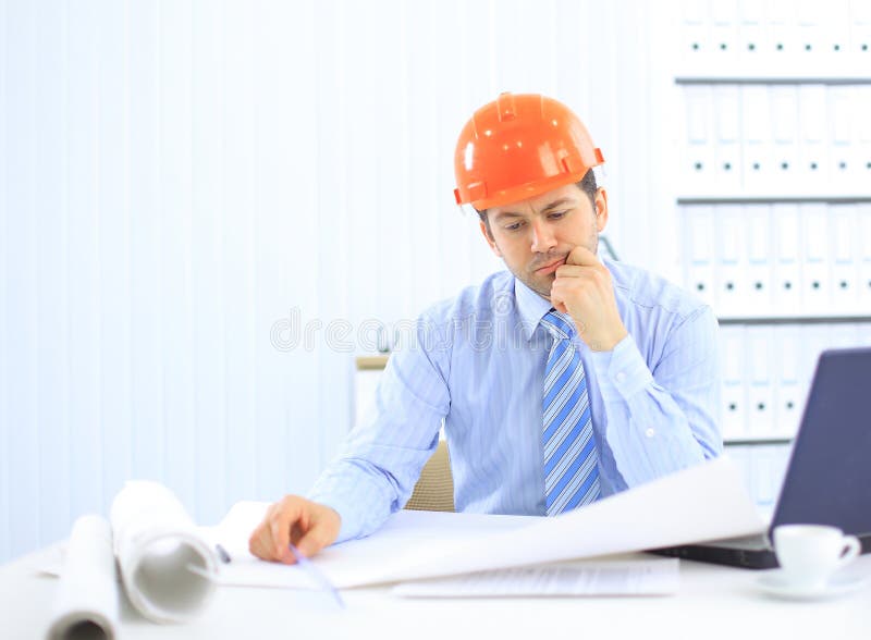 Architect looking working in office at desk. royalty free stock photography