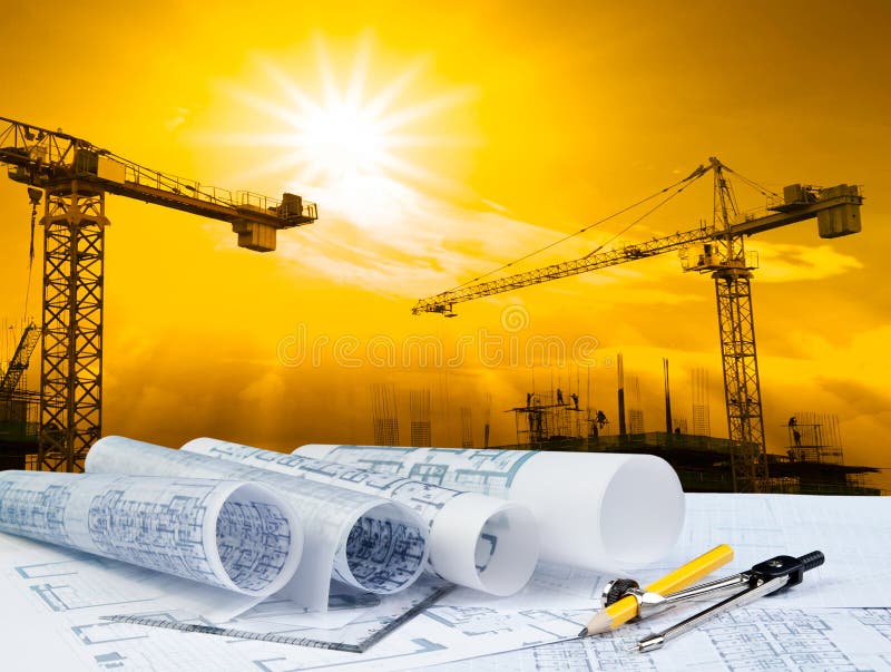 Architect plan on working table with crane and building construction background