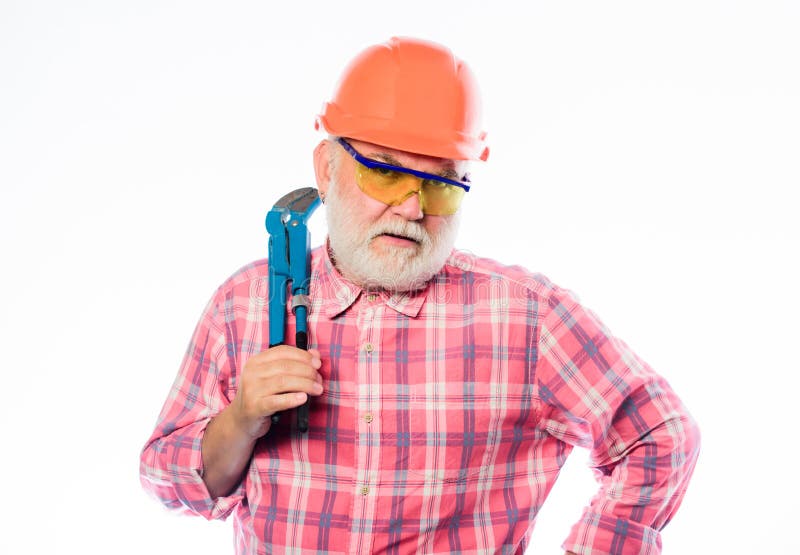 Architect repair and fix. engineer worker. build and construction. professional repairman in helmet with gas wrench stock image Architect repair and fix. engineer worker. build and construction. professional repairman in helmet with gas wrench stock image