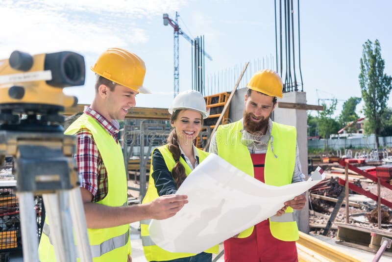 Architect sharing ideas about plan of building project on construction site