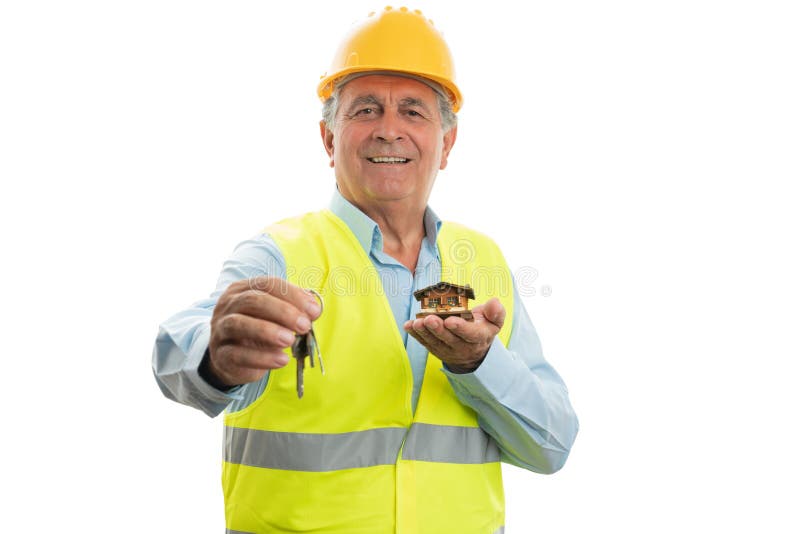 Architect showing keys and small house stock images Architect showing keys and small house stock images