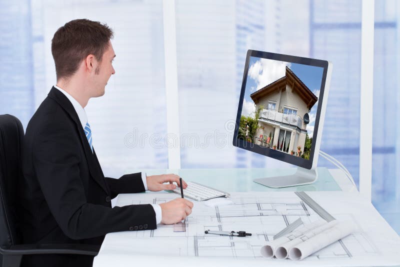 Architect Working On Blueprint While Looking At Co royalty free stock photo Architect Working On Blueprint While Looking At Co royalty free stock photo