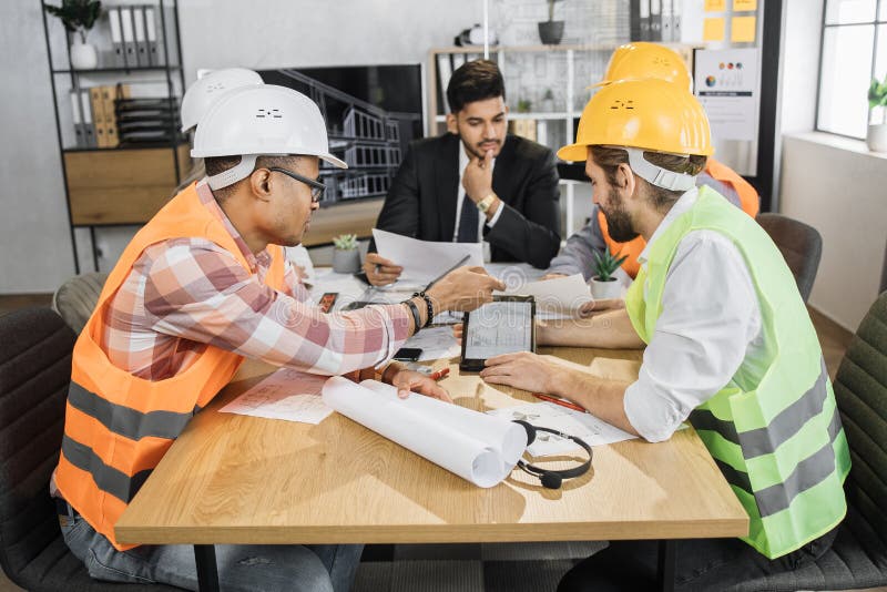 Architects, designers and engineers leading conference at office. Brainstorming concept. stock images