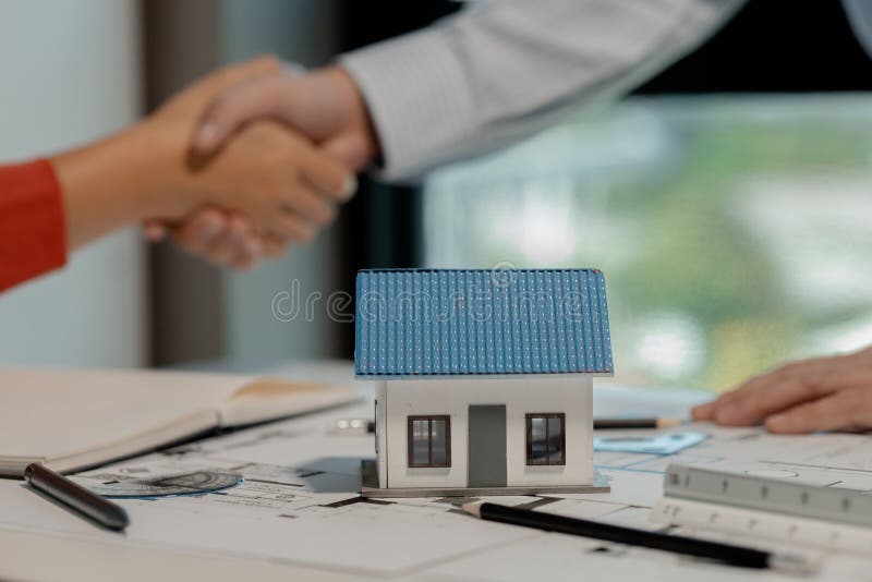 Architects and engineers shake hands as the work they've done together has been approved stock image