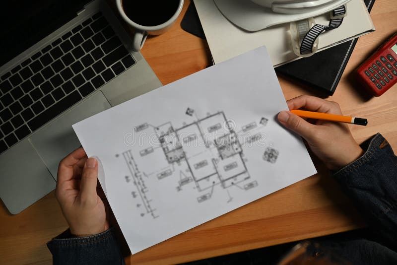 Architects Man Using Laptop, Working on Construction Plans on Wooden