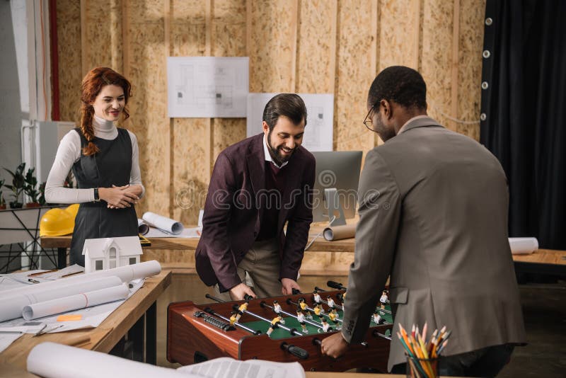 Architects playing table football stock image