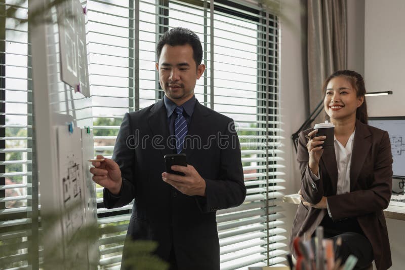 Architects work with engineers and contractors in the office to check the accuracy of the first draft plan, blueprint on the desk stock images
