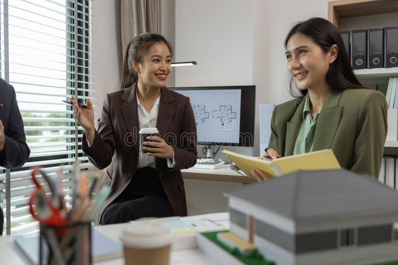 Architects work with engineers and contractors in the office to check the accuracy of the first draft plan, blueprint on the desk royalty free stock image