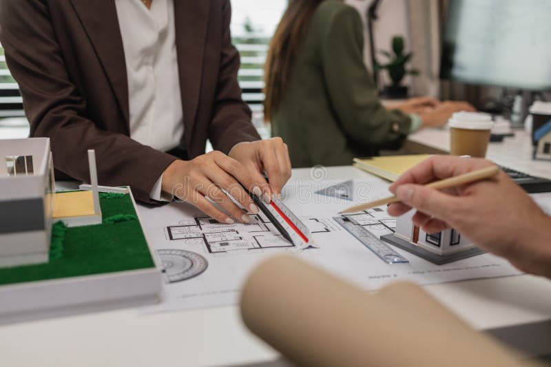 Architects work with engineers and contractors in the office to check the accuracy of the first draft plan, blueprint on the desk royalty free stock photos