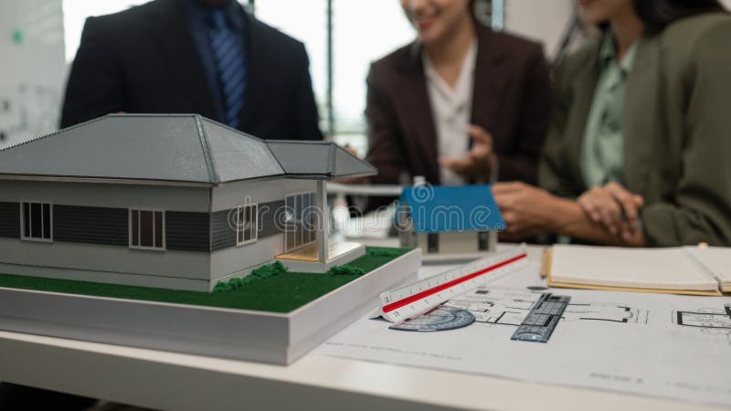 Architects work with engineers and contractors in the office to check the accuracy of the first draft plan, blueprint on the desk royalty free stock photography