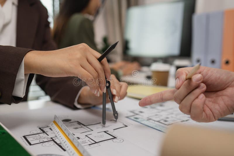 Architects work with engineers and contractors in the office to check the accuracy of the first draft plan, blueprint on the desk royalty free stock photography