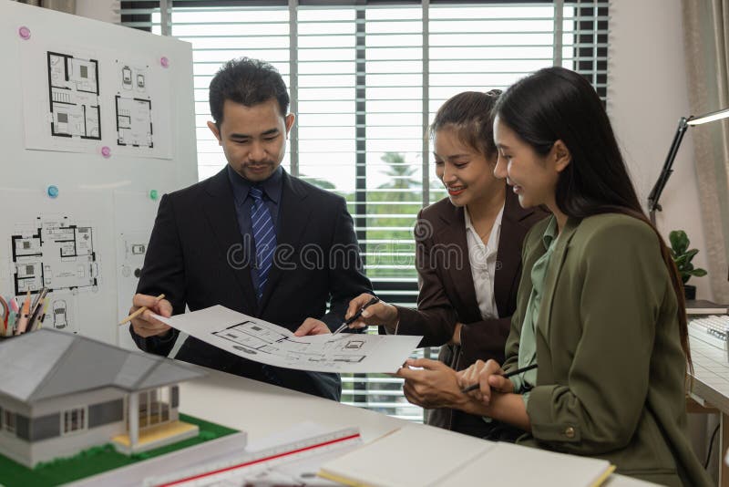 Architects work with engineers and contractors in the office to check the accuracy of the first draft plan, blueprint on the desk royalty free stock images
