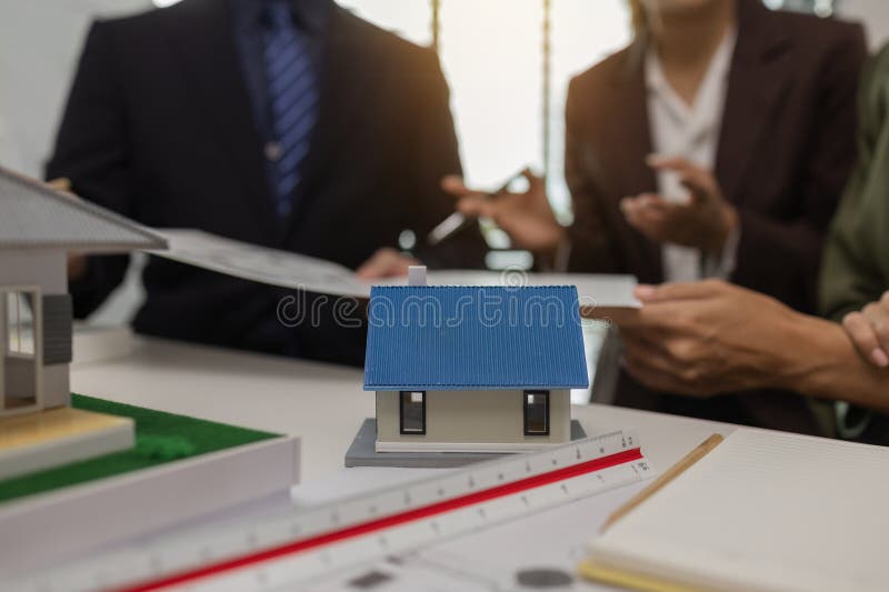 Architects work with engineers and contractors in the office to check the accuracy of the first draft plan, blueprint on the desk royalty free stock photo
