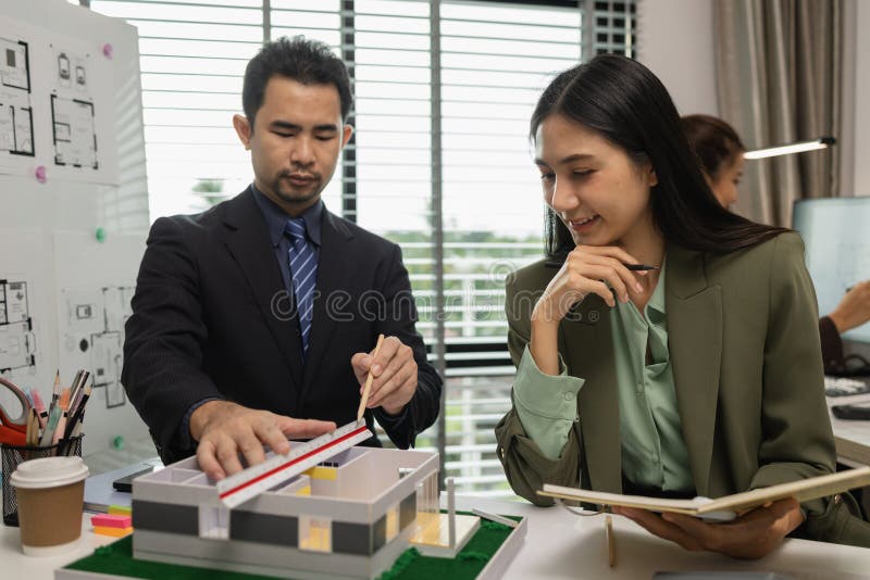 Architects work with engineers and contractors in the office to check the accuracy of the first draft plan, blueprint on the desk royalty free stock images