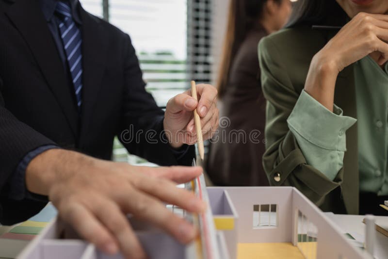 Architects work with engineers and contractors in the office to check the accuracy of the first draft plan, blueprint on the desk stock photos