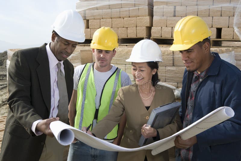 Architects And Workers In Discussion At Site stock photos