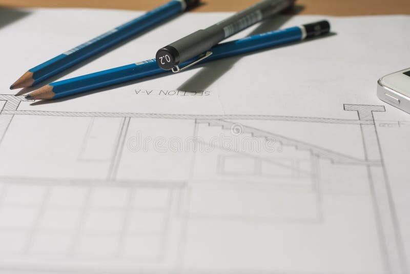Architectural blueprints and blueprint rolls and a drawing instruments royalty free stock photos