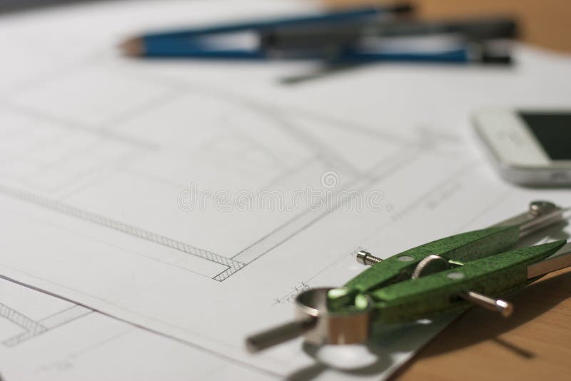 Architectural blueprints and blueprint rolls and a drawing instruments stock image