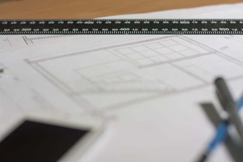 Architectural blueprints and blueprint rolls and a drawing instruments royalty free stock photography