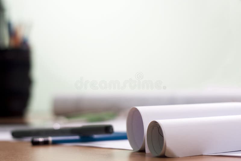 Architectural blueprints and blueprint rolls and a drawing instruments stock photography