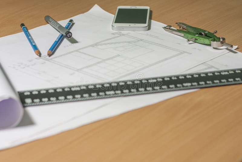 Architectural blueprints and blueprint rolls and a drawing instruments royalty free stock photos