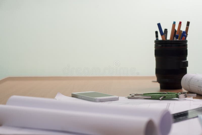 Architectural blueprints and blueprint rolls and a drawing instruments stock photo
