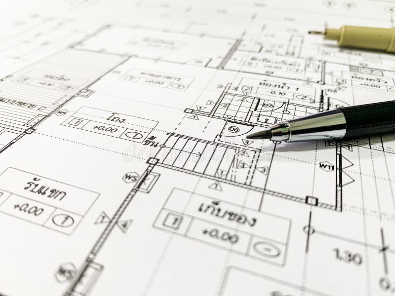 Architectural blueprints and a drawing instruments on the worktable stock images