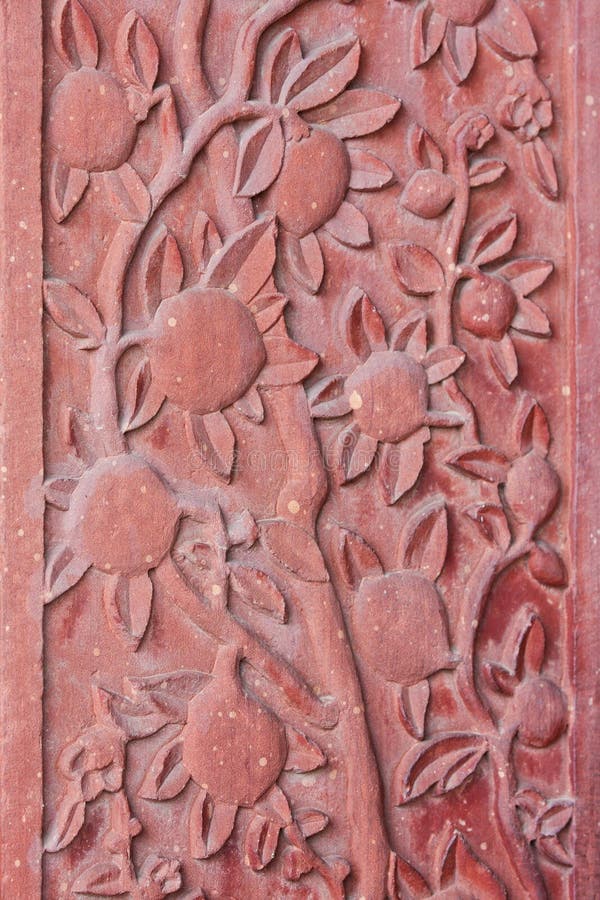 Architectural detail of carved flowers at the palace of Fatehpur Sikri, ancient city founded by Mughal emperor Akbar, one of the best preserved collections of Indian Mughal architecture in Agra, Uttar Pradesh, India