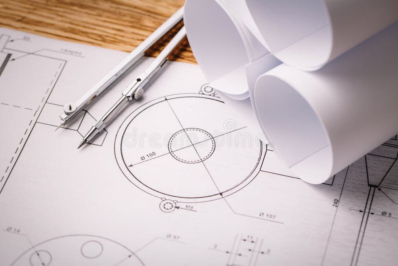 Architectural Drawing and Drawing Rolls and a Drawing Instruments on the Worktable. Stock Image