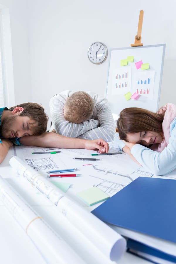 Architectural team sleeping after long night stock photography