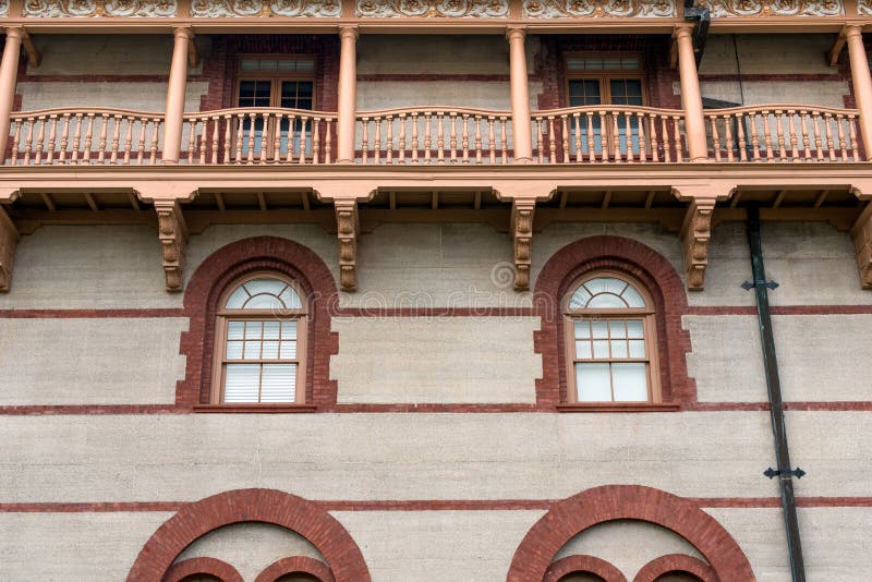 Architecture of building with brick outlined windows and wooden balcony. Architecture of building with brick outlined windows and wooden balcony