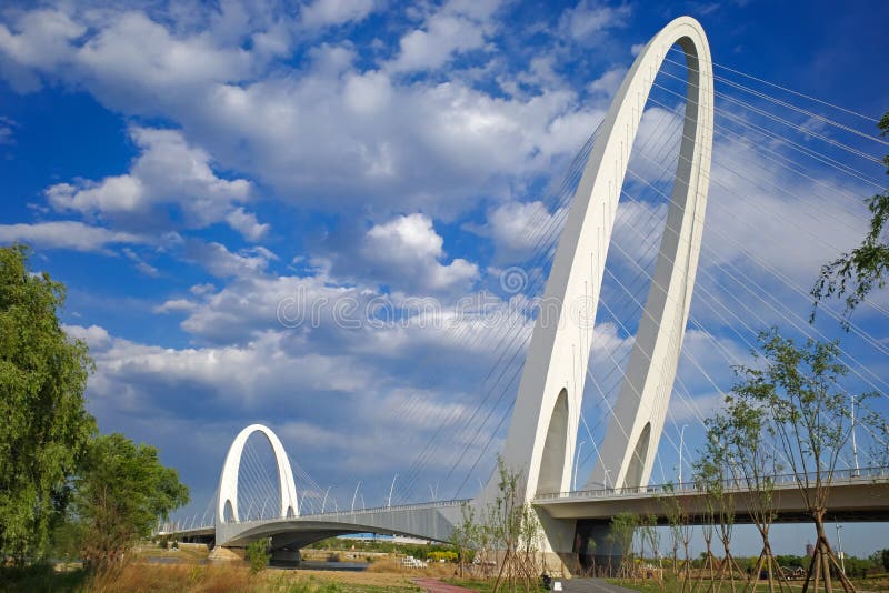 Architecture of cable stayed bridge with cloudy blue sky royalty free stock image