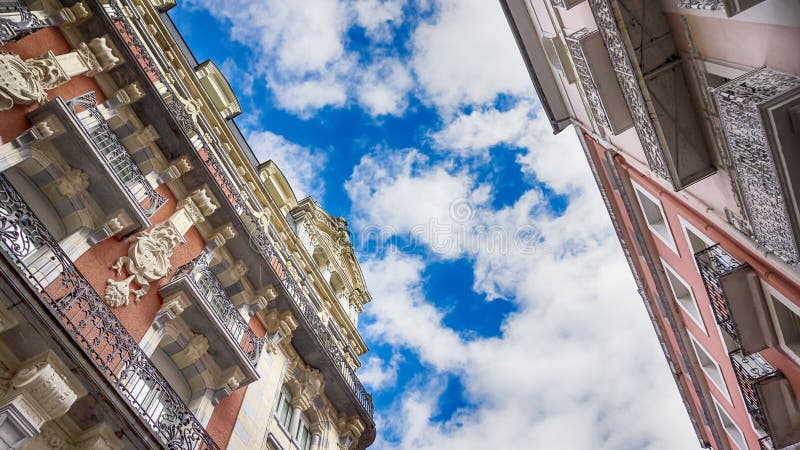 Architecture of Lourdes, France. Beautiful old houses on one of the streets and sky. Details, 16:9 panoramic format. Architecture of Lourdes, France. Beautiful stock photography Architecture of Lourdes, France. Beautiful old houses on one of the streets and sky. Details, 16:9 panoramic format. Architecture of Lourdes, France. Beautiful stock photography