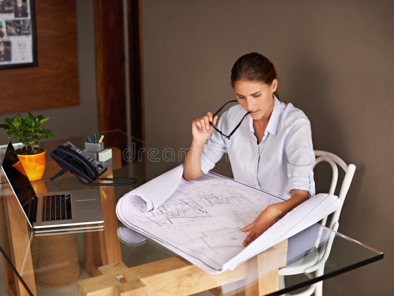 Architecture, thinking and woman with blueprint for ideas, development and planning a design at her office desk royalty free stock photos