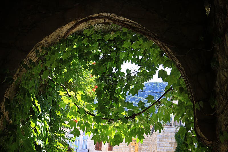 An archway in the Lebanese village of Douma in lush green. An archway in the Lebanese village of Douma in lush green.