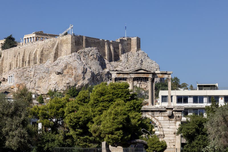 Athens, Greece - October 19, 2022: Arch of Hadrian, Roman triumphal arch, remains of a monumental ancient gate. Acropolis hill in the distance. Athens, Greece - October 19, 2022: Arch of Hadrian, Roman triumphal arch, remains of a monumental ancient gate. Acropolis hill in the distance