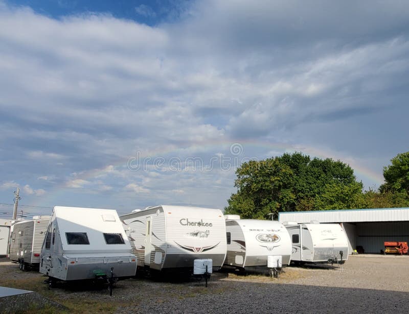 Rainbow in the sky over recreational vehicle lot. Rainbow in the sky over recreational vehicle lot