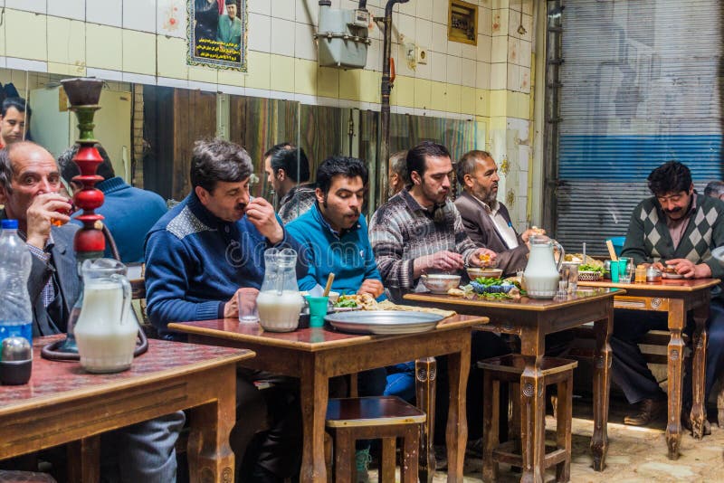 ARDABIL, IRAN - APRIL 10, 2018: People eat Dizi Abgoosht , traditional Iranian stew, in a local tea house in Ardabil, Ir