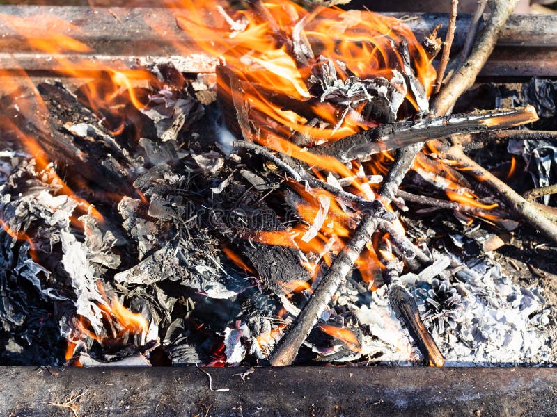 Burning tree branches in outdoor brazier close up. Burning tree branches in outdoor brazier close up